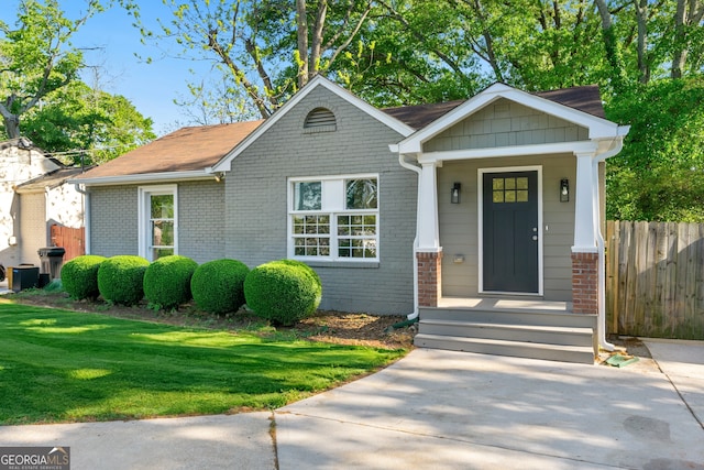 1258 Lyle Ave, East Point, GA 30344 - view of front of home with brick siding, fence, and a front yard