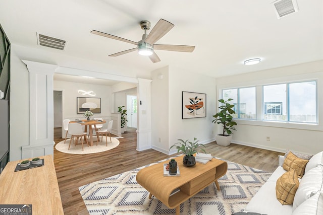1258 Lyle Ave, East Point, GA 30344 - living area with visible vents, decorative columns, and light wood-type flooring