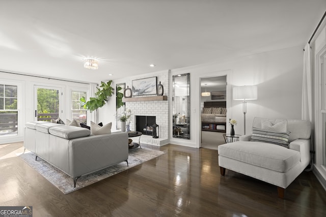 4440 Webb Bridge Rd, Alpharetta, GA 30005 - living area featuring a brick fireplace, wood finished floors, recessed lighting, and crown molding