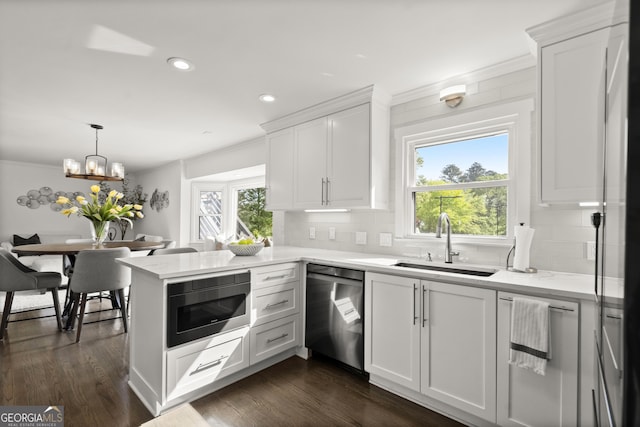 4440 Webb Bridge Rd, Alpharetta, GA 30005 - kitchen with appliances with stainless steel finishes, a sink, tasteful backsplash, ornamental molding, and a peninsula