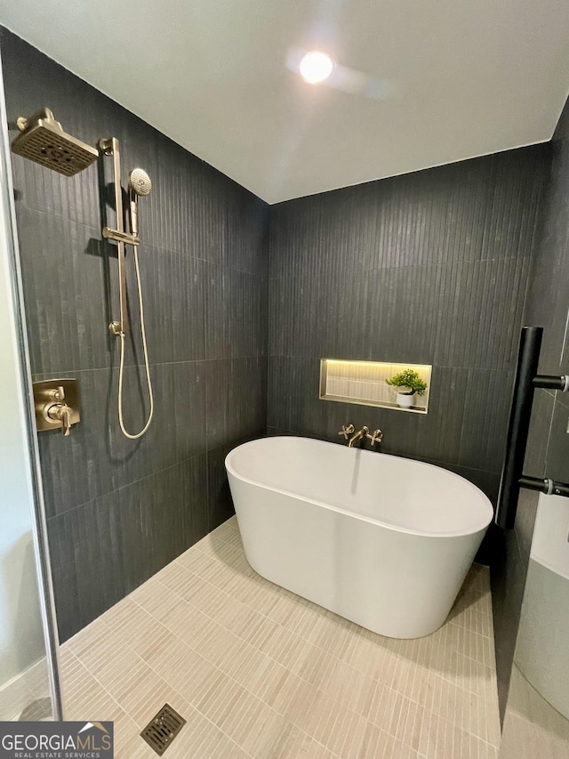 4440 Webb Bridge Rd, Alpharetta, GA 30005 - full bath featuring a tile shower, a freestanding tub, and tile patterned floors