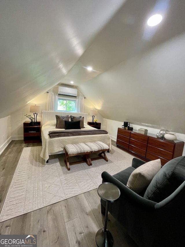 4440 Webb Bridge Rd, Alpharetta, GA 30005 - bedroom featuring wood finished floors, a wall mounted AC, vaulted ceiling, and baseboards