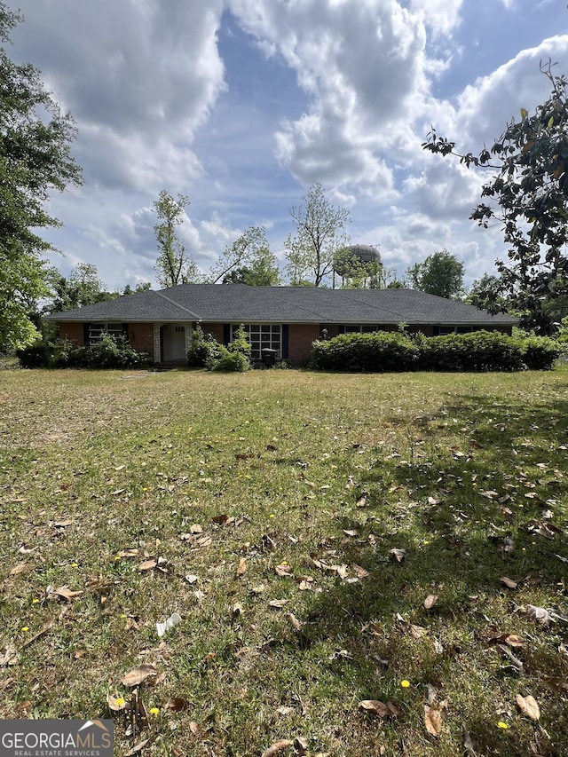 ranch-style house with a front lawn