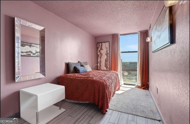 375 Ralph Mcgill Blvd # 1503, Atlanta, GA 30312 - bedroom featuring a textured ceiling and wood tiled floors