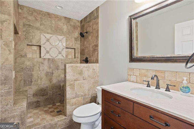 full bathroom with walk in shower, toilet, vanity, tasteful backsplash, and a textured ceiling