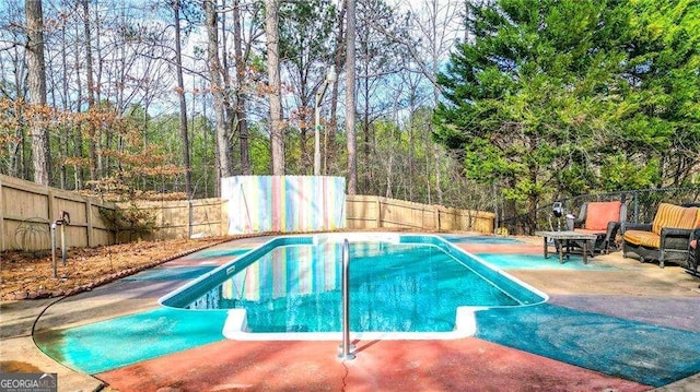 view of swimming pool featuring a fenced backyard, a patio, and a fenced in pool