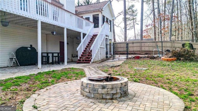 view of yard with fence, an outdoor fire pit, a gate, and a patio