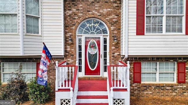 entrance to property featuring brick siding
