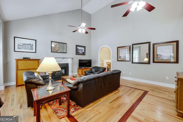 90 Hart Ave, Athens, GA 30606 - living area with a ceiling fan, a premium fireplace, light wood-type flooring, high vaulted ceiling, and arched walkways