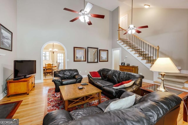 90 Hart Ave, Athens, GA 30606 - living area with a ceiling fan, stairs, high vaulted ceiling, a chandelier, and light wood-style floors