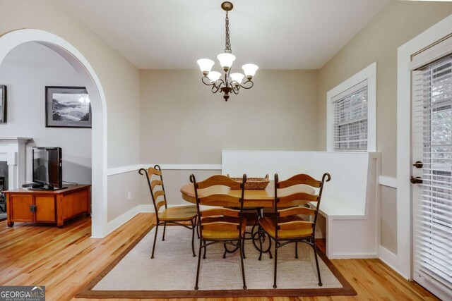90 Hart Ave, Athens, GA 30606 - dining space featuring light wood-style flooring, a chandelier, and arched walkways