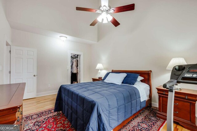 90 Hart Ave, Athens, GA 30606 - bedroom featuring light wood-type flooring, a spacious closet, ceiling fan, and lofted ceiling