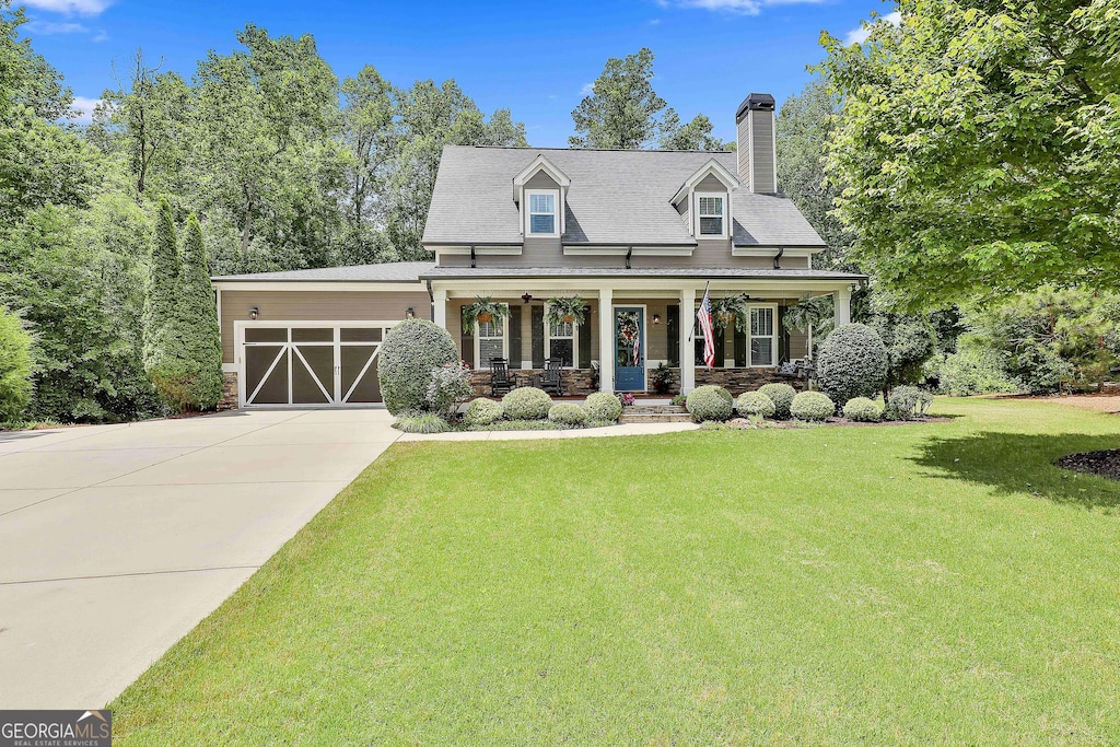 42 W Shore Trce, Newnan, GA 30263 - cape cod-style house with a porch, a garage, a front yard, driveway, and a chimney