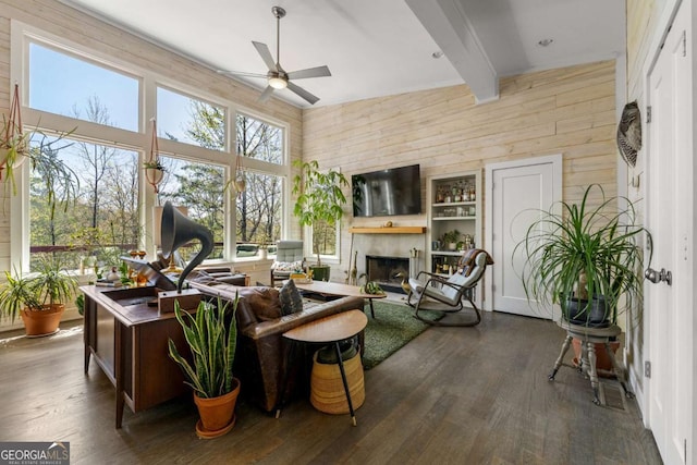 124 Nichols Branch Ln, Clayton, GA 30525 - living room with wood walls, ceiling fan, plenty of natural light, dark wood-style floors, and a fireplace