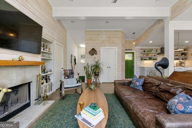124 Nichols Branch Ln, Clayton, GA 30525 - living area featuring a premium fireplace, wood walls, and beamed ceiling