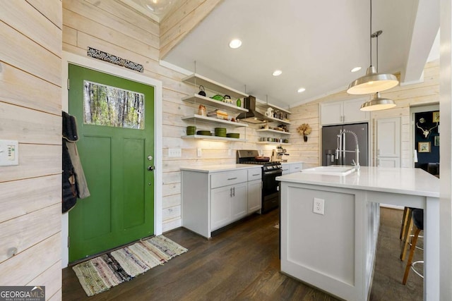 124 Nichols Branch Ln, Clayton, GA 30525 - kitchen with stainless steel gas range, wood walls, high end fridge, light countertops, and open shelves