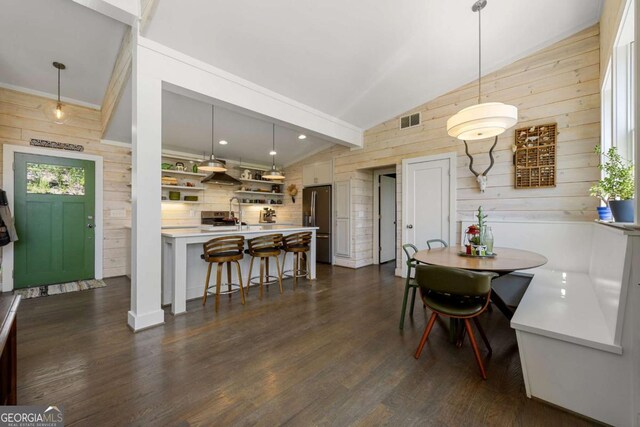 124 Nichols Branch Ln, Clayton, GA 30525 - dining space with wooden walls, lofted ceiling, and dark wood-type flooring