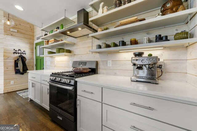 124 Nichols Branch Ln, Clayton, GA 30525 - kitchen featuring open shelves, stainless steel gas stove, wall chimney exhaust hood, wood walls, and dark wood finished floors