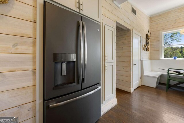 124 Nichols Branch Ln, Clayton, GA 30525 - kitchen featuring stainless steel fridge with ice dispenser, dark wood-style floors, and wood walls