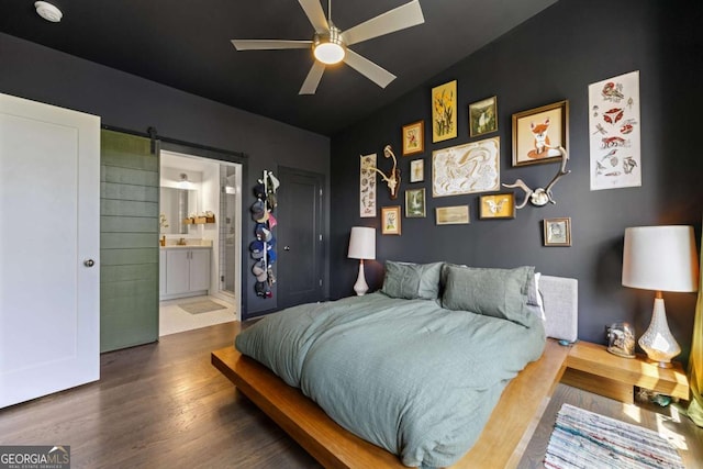 124 Nichols Branch Ln, Clayton, GA 30525 - bedroom with wood finished floors, a barn door, ensuite bathroom, and a ceiling fan