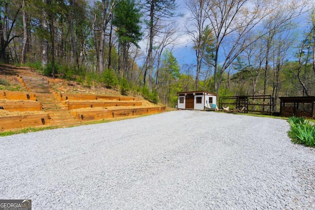 124 Nichols Branch Ln, Clayton, GA 30525 - view of yard with driveway and a shed