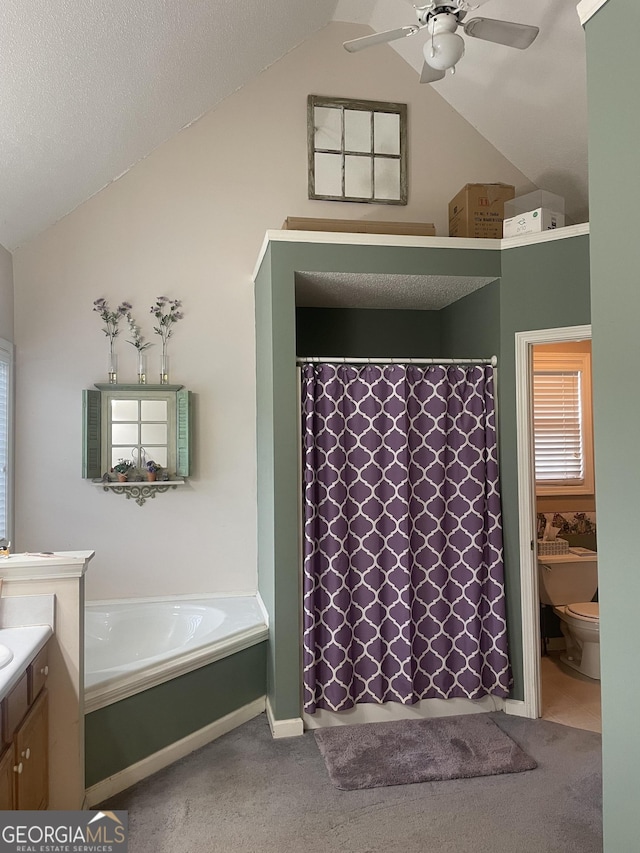 full bath featuring a shower with curtain, vanity, toilet, a ceiling fan, and vaulted ceiling