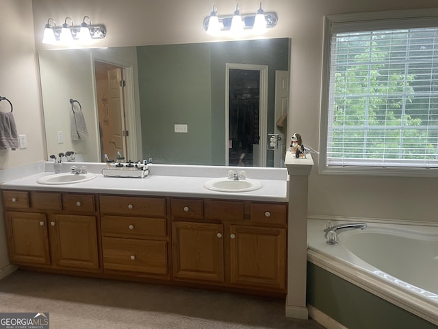 bathroom with double vanity, a bath, and a sink