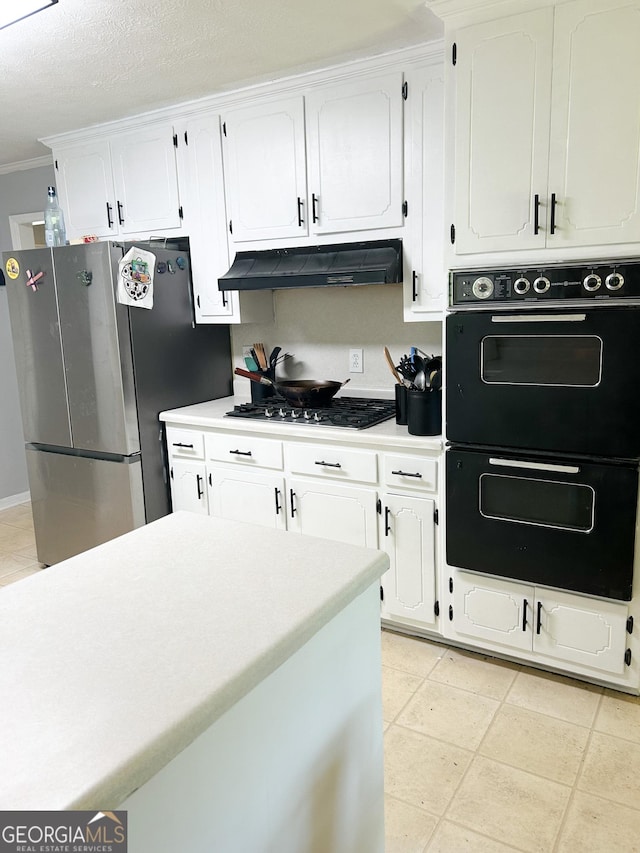 15 Laurelwood Cir, Griffin, GA 30224 - kitchen featuring under cabinet range hood, stainless steel appliances, white cabinetry, light countertops, and crown molding