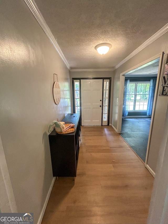 15 Laurelwood Cir, Griffin, GA 30224 - foyer featuring a textured ceiling, light wood-type flooring, baseboards, and crown molding
