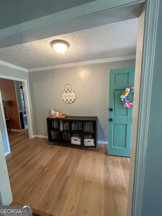15 Laurelwood Cir, Griffin, GA 30224 - hall featuring wood finished floors, crown molding, a textured ceiling, and baseboards