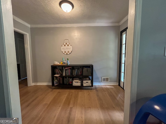 15 Laurelwood Cir, Griffin, GA 30224 - corridor with wood finished floors, baseboards, crown molding, and a textured ceiling