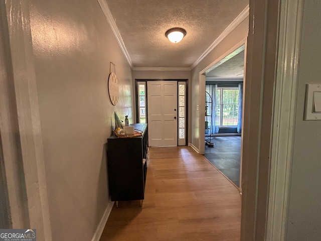15 Laurelwood Cir, Griffin, GA 30224 - entryway with wood finished floors, a textured ceiling, baseboards, and crown molding