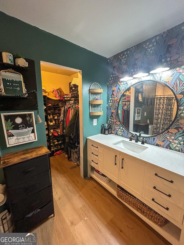 15 Laurelwood Cir, Griffin, GA 30224 - full bath featuring wallpapered walls, wood finished floors, a walk in closet, and vanity