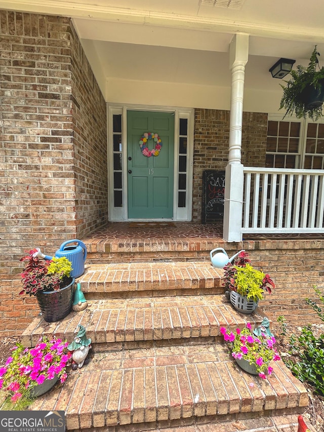15 Laurelwood Cir, Griffin, GA 30224 - view of exterior entry with brick siding and a porch