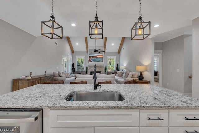2710 Sandy Irwin Ct SW, Marietta, GA 30064 - kitchen with white cabinets, a sink, vaulted ceiling with beams, a ceiling fan, and light stone countertops