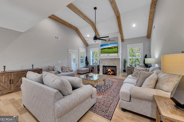 2710 Sandy Irwin Ct SW, Marietta, GA 30064 - living area featuring a stone fireplace, visible vents, a ceiling fan, beam ceiling, and high vaulted ceiling