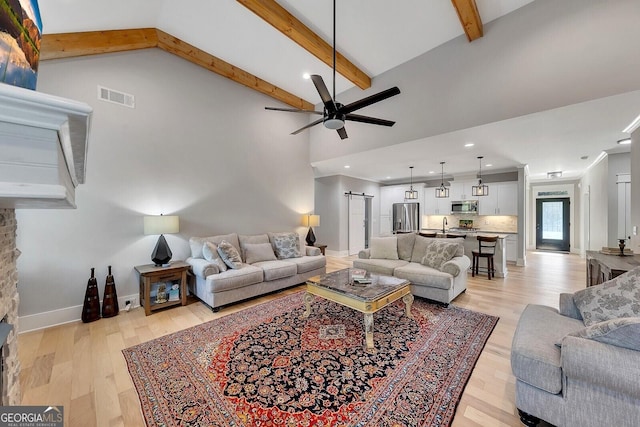 2710 Sandy Irwin Ct SW, Marietta, GA 30064 - living room featuring beamed ceiling, visible vents, light wood-type flooring, and ceiling fan