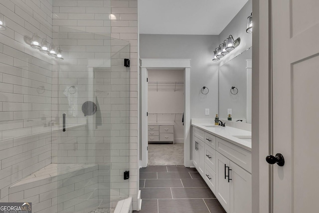 2710 Sandy Irwin Ct SW, Marietta, GA 30064 - full bath featuring a spacious closet, tile patterned flooring, double vanity, a sink, and a stall shower