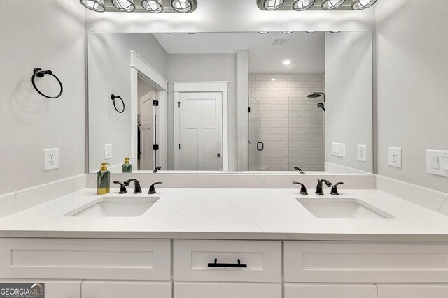 2710 Sandy Irwin Ct SW, Marietta, GA 30064 - bathroom featuring double vanity, visible vents, a stall shower, and a sink