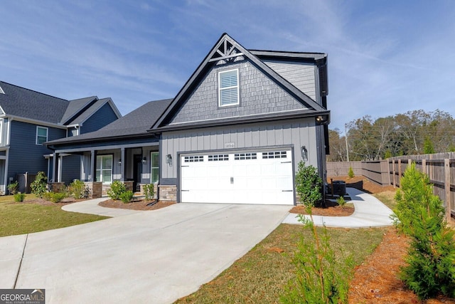 2710 Sandy Irwin Ct SW, Marietta, GA 30064 - craftsman-style home featuring driveway, a porch, stone siding, fence, and board and batten siding