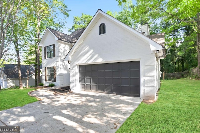 view of front of house featuring concrete driveway, brick siding, a front yard, and a garage