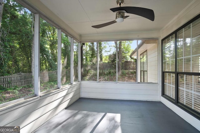 unfurnished sunroom with a ceiling fan