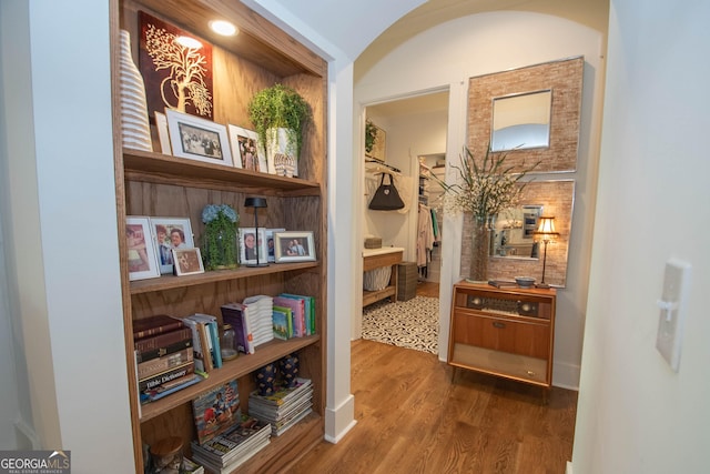 hall featuring wood finished floors and baseboards