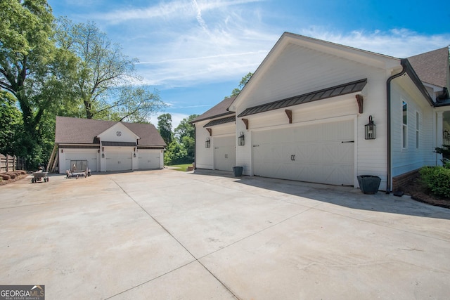 view of home's exterior featuring a standing seam roof and roof with shingles