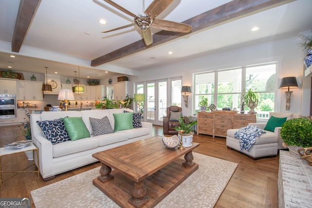 living area featuring ceiling fan, recessed lighting, and beamed ceiling