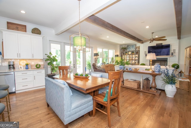dining space with a healthy amount of sunlight, beamed ceiling, and ceiling fan with notable chandelier