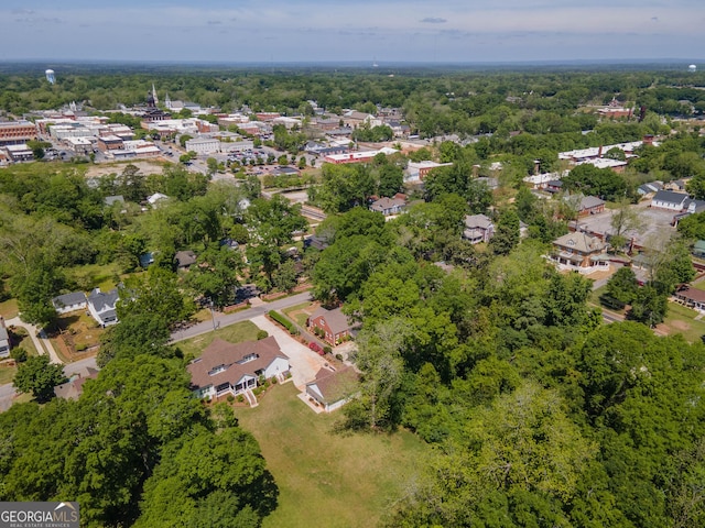 birds eye view of property featuring a wooded view and a residential view