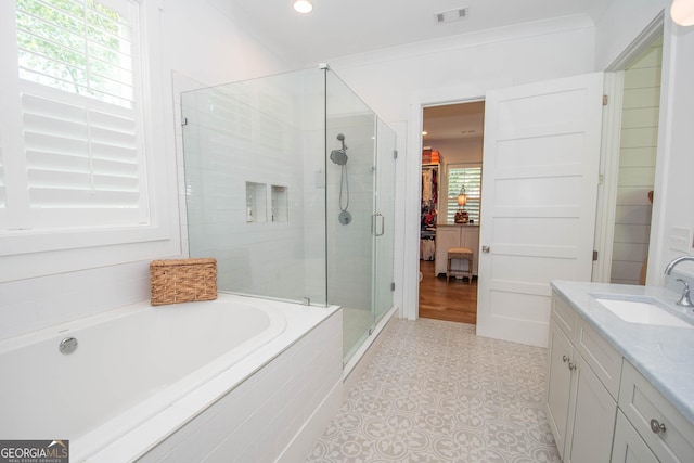 bathroom with recessed lighting, a shower stall, vanity, a bath, and visible vents