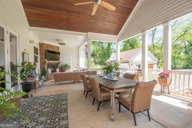 view of patio / terrace with ceiling fan, outdoor dining space, and an outdoor living space with a fireplace