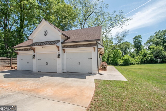 garage with driveway and fence